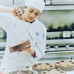 Meghna at work, at CSCA making cakes.