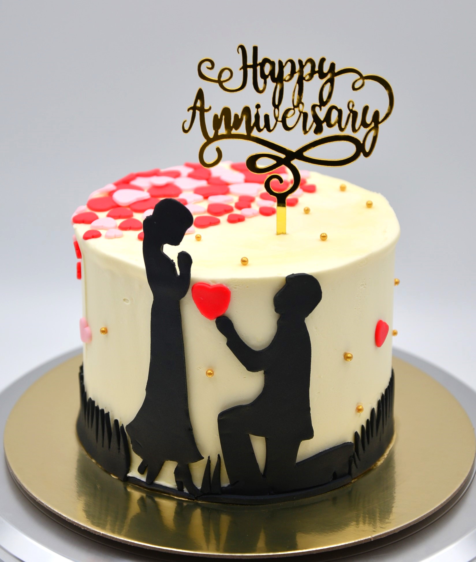 Wedding Anniversary Cake. Husband and wife with a heart symbol.